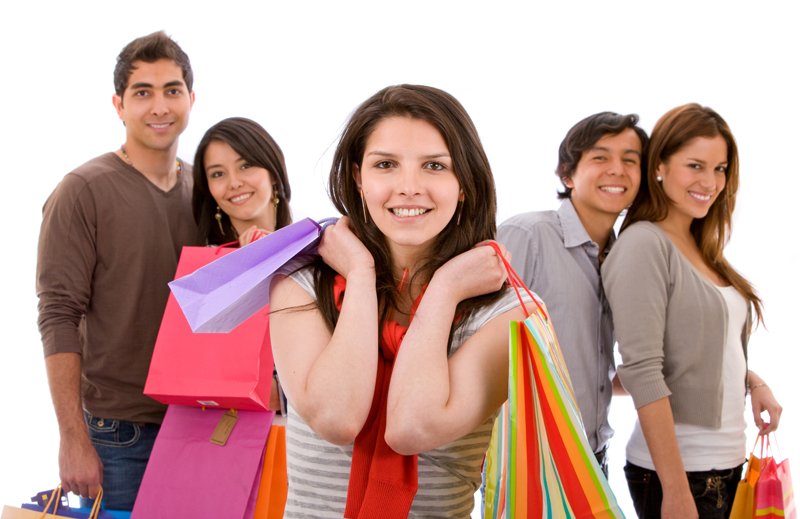 Casual woman with shopping bags and some people behind her - isolated on white